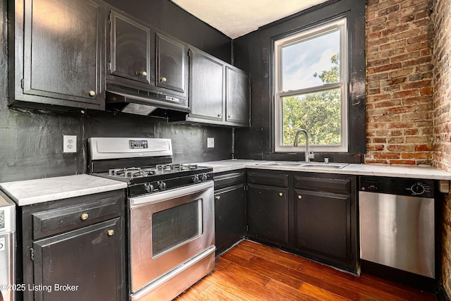 1337 S 1st St Unit 3R, Louisville, KY 40208 - kitchen with appliances with stainless steel finishes, a sink, under cabinet range hood, and wood finished floors