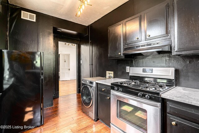 1337 S 1st St Unit 3R, Louisville, KY 40208 - kitchen featuring stainless steel gas range oven, under cabinet range hood, freestanding refrigerator, light wood-style flooring, and light countertops