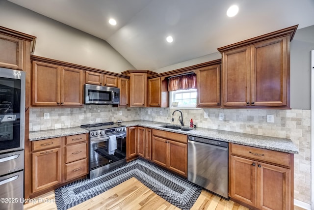 4605 Clarkhurst Cir, Smithfield, KY 40068 - kitchen with appliances with stainless steel finishes, a sink, vaulted ceiling, light wood-style flooring, and light stone counters