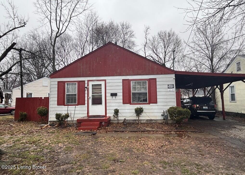 1625 Clara Ave, Louisville, KY 40215 - view of front of property with an attached carport and driveway