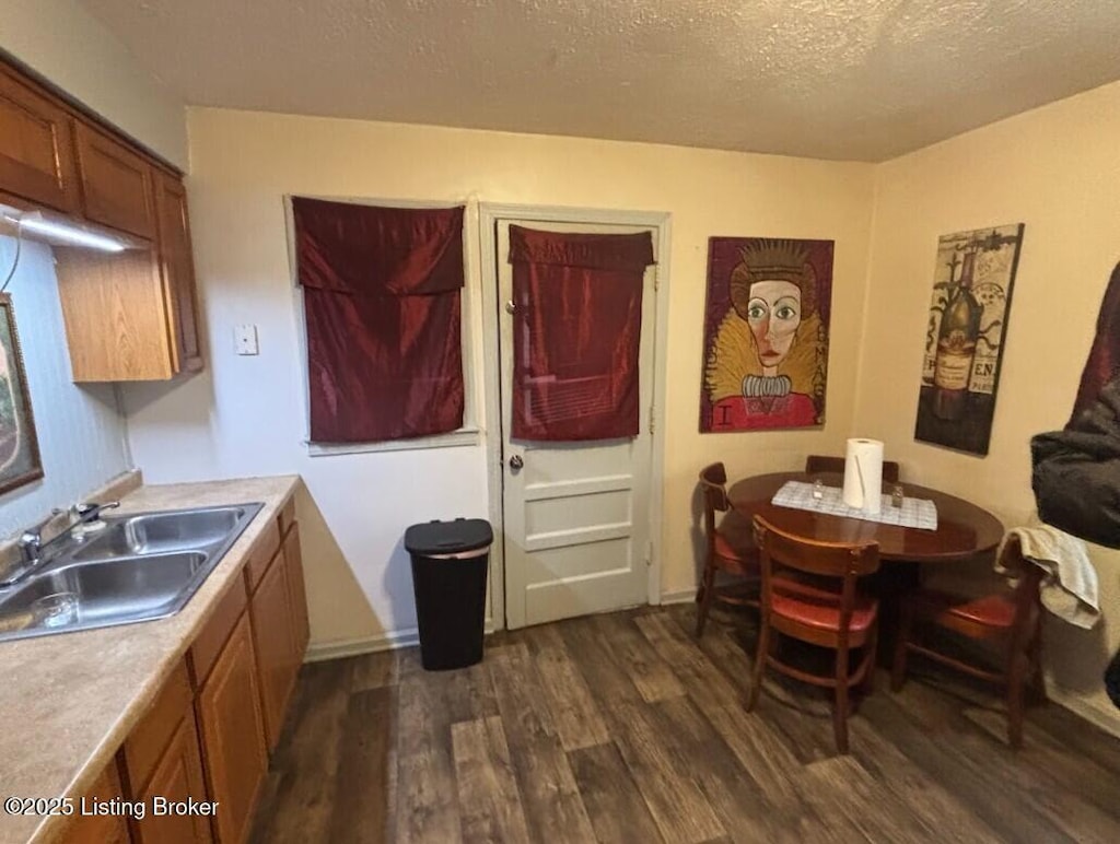 1625 Clara Ave, Louisville, KY 40215 - kitchen with a sink, dark wood-style flooring, brown cabinets, light countertops, and a textured ceiling
