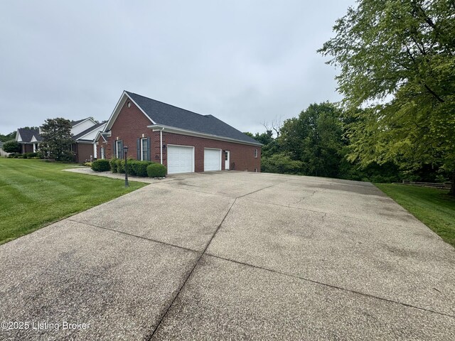 144 Woodhill Rd, Bardstown, KY 40004 - view of home's exterior with brick siding, a lawn, an attached garage, and concrete driveway
