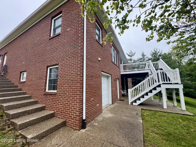 144 Woodhill Rd, Bardstown, KY 40004 - view of home's exterior featuring stairs, an attached garage, and brick siding