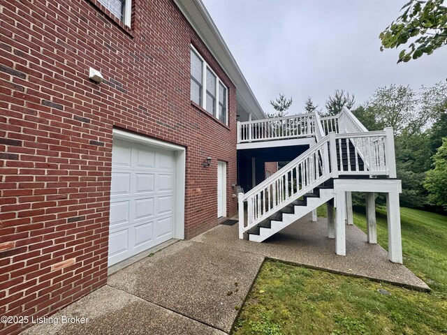144 Woodhill Rd, Bardstown, KY 40004 - view of side of property with a deck, a garage, brick siding, a yard, and driveway