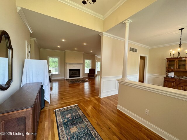 144 Woodhill Rd, Bardstown, KY 40004 - living area featuring ornate columns, crown molding, wood finished floors, a glass covered fireplace, and wainscoting