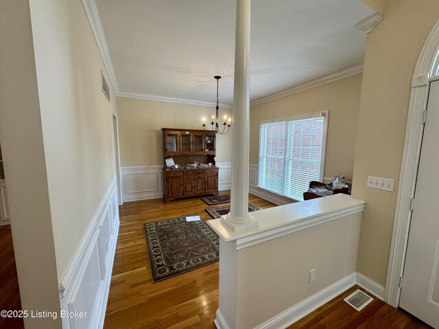 144 Woodhill Rd, Bardstown, KY 40004 - hall featuring crown molding, a chandelier, wood finished floors, wainscoting, and ornate columns
