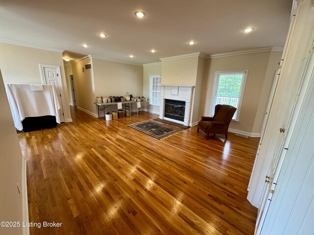144 Woodhill Rd, Bardstown, KY 40004 - living area featuring crown molding, wood finished floors, baseboards, a glass covered fireplace, and recessed lighting