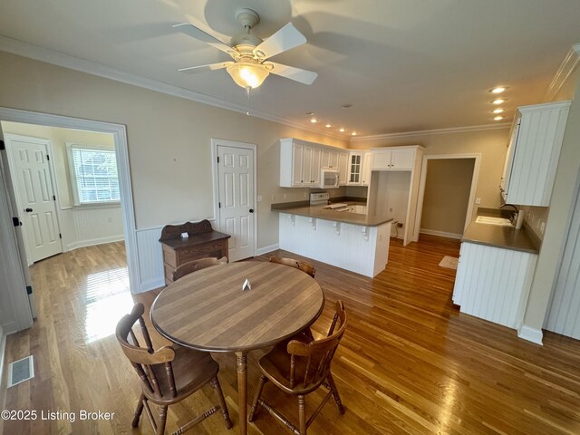 144 Woodhill Rd, Bardstown, KY 40004 - dining area with wood finished floors, ornamental molding, ceiling fan, recessed lighting, and wainscoting