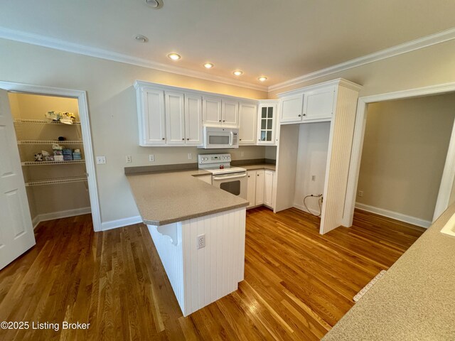 144 Woodhill Rd, Bardstown, KY 40004 - kitchen featuring white appliances, white cabinets, glass insert cabinets, dark wood-type flooring, and ornamental molding
