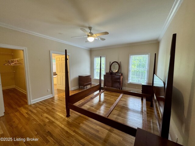 144 Woodhill Rd, Bardstown, KY 40004 - bedroom featuring wood finished floors, crown molding, baseboards, a spacious closet, and ceiling fan