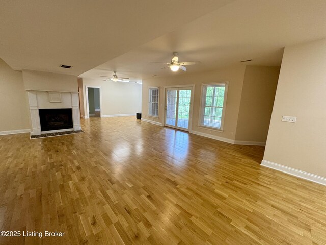 144 Woodhill Rd, Bardstown, KY 40004 - unfurnished living room with light wood finished floors, baseboards, ceiling fan, and a fireplace