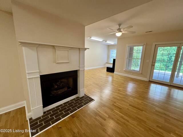 144 Woodhill Rd, Bardstown, KY 40004 - unfurnished living room with a fireplace, light wood-style floors, ceiling fan, and baseboards