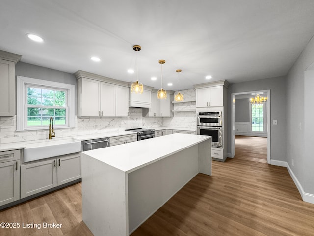 101 Harry Rucker Rd, Bardstown, KY 40004 - kitchen featuring a sink, appliances with stainless steel finishes, decorative backsplash, light countertops, and a kitchen island