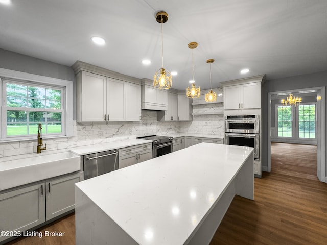 101 Harry Rucker Rd, Bardstown, KY 40004 - kitchen with stainless steel appliances, tasteful backsplash, a sink, a kitchen island, and dark wood finished floors