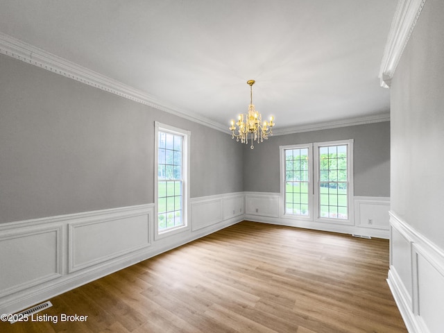 101 Harry Rucker Rd, Bardstown, KY 40004 - unfurnished room with a chandelier, ornamental molding, wainscoting, wood finished floors, and a decorative wall