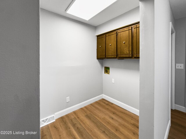 101 Harry Rucker Rd, Bardstown, KY 40004 - laundry room featuring washer hookup, cabinet space, wood finished floors, and baseboards