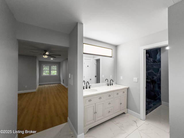 101 Harry Rucker Rd, Bardstown, KY 40004 - full bathroom featuring a ceiling fan, double vanity, marble look tile flooring, and baseboards