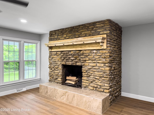 101 Harry Rucker Rd, Bardstown, KY 40004 - detailed view of baseboards, wood finished floors, a fireplace with raised hearth, and recessed lighting
