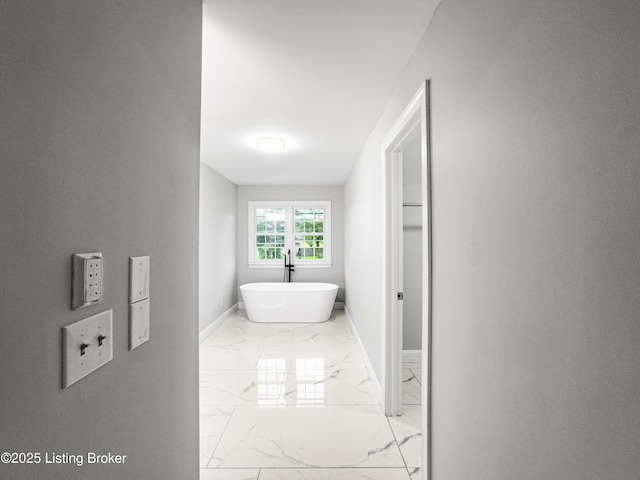 101 Harry Rucker Rd, Bardstown, KY 40004 - bathroom featuring marble look tile flooring, baseboards, and a freestanding tub