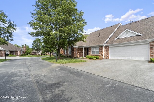10106 Blossom Tree Way, Louisville, KY 40241 - view of front facade featuring driveway, brick siding, a shingled roof, and an attached garage