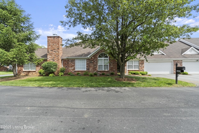 10106 Blossom Tree Way, Louisville, KY 40241 - view of front of property with driveway, a front yard, a chimney, brick siding, and a garage