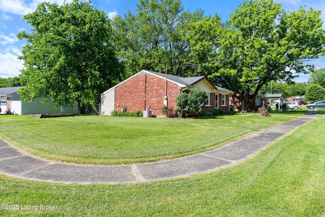 5612 Oakridge Pl, Louisville, KY 40229 - view of home's exterior with brick siding, a yard, and central AC unit