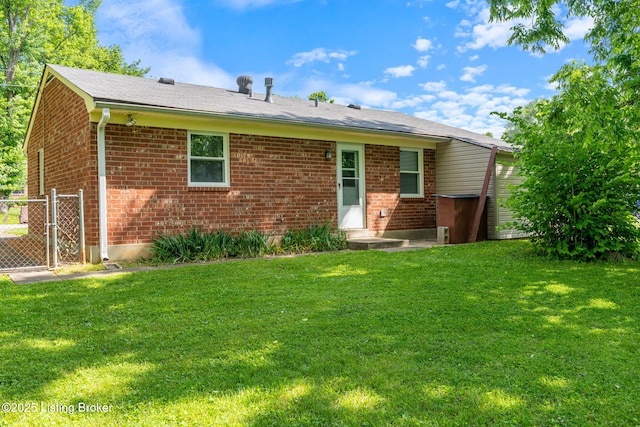 5612 Oakridge Pl, Louisville, KY 40229 - rear view of property featuring brick siding, a lawn, and a gate