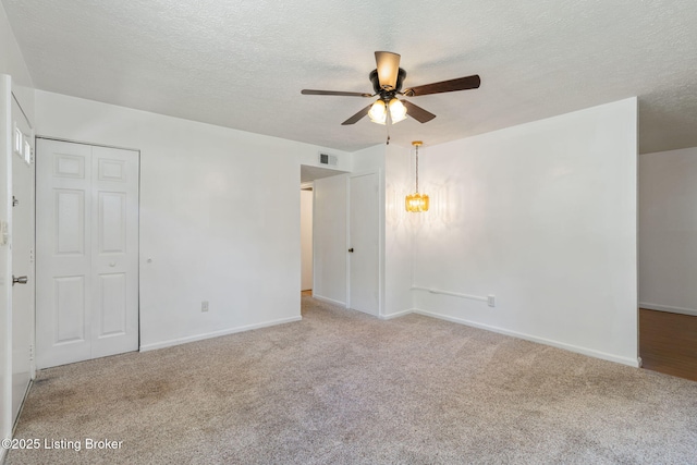 5612 Oakridge Pl, Louisville, KY 40229 - carpeted empty room with ceiling fan, a textured ceiling, baseboards, and a chandelier