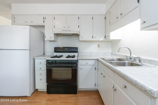 5612 Oakridge Pl, Louisville, KY 40229 - kitchen featuring freestanding refrigerator, gas range oven, a sink, under cabinet range hood, and light wood-style flooring