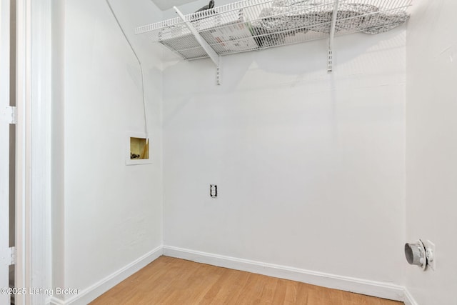 5612 Oakridge Pl, Louisville, KY 40229 - washroom featuring baseboards, light wood-style flooring, and washer hookup