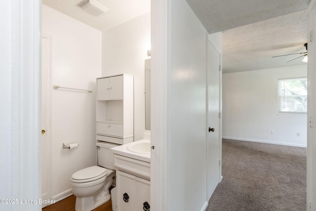 5612 Oakridge Pl, Louisville, KY 40229 - half bathroom with vanity, ceiling fan, a textured ceiling, toilet, and baseboards
