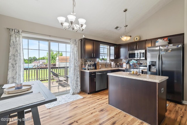 238 Crossfield Dr, Mt Washington, KY 40047 - kitchen with appliances with stainless steel finishes, dark brown cabinetry, light countertops, backsplash, and hanging light fixtures