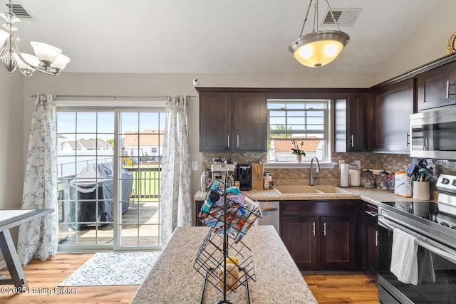 238 Crossfield Dr, Mt Washington, KY 40047 - kitchen with appliances with stainless steel finishes, dark brown cabinets, light countertops, and light wood-type flooring