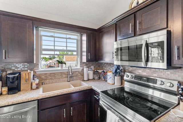 238 Crossfield Dr, Mt Washington, KY 40047 - kitchen with appliances with stainless steel finishes, a sink, dark brown cabinetry, tasteful backsplash, and light countertops