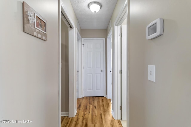 238 Crossfield Dr, Mt Washington, KY 40047 - hall with light wood-type flooring, baseboards, and a textured ceiling
