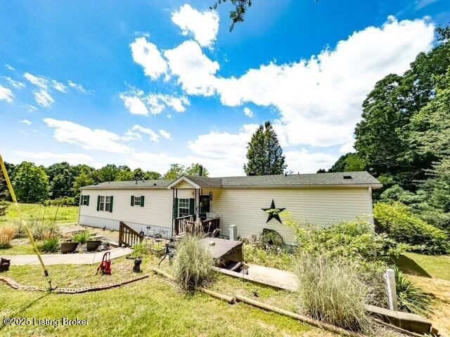 1073 Post-Tousey Rd Unit C, Caneyville, KY 42721 - rear view of property featuring a yard