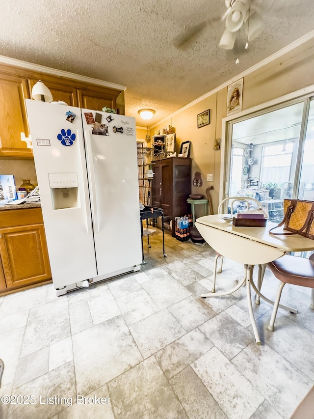 1073 Post-Tousey Rd Unit C, Caneyville, KY 42721 - kitchen with white refrigerator with ice dispenser, ornamental molding, a textured ceiling, ceiling fan, and brown cabinetry