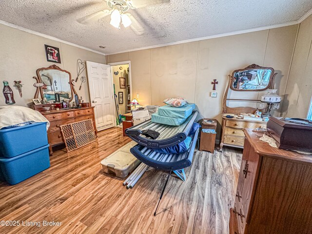 1073 Post-Tousey Rd Unit C, Caneyville, KY 42721 - bedroom featuring wood finished floors, ornamental molding, a textured ceiling, ceiling fan, and a decorative wall