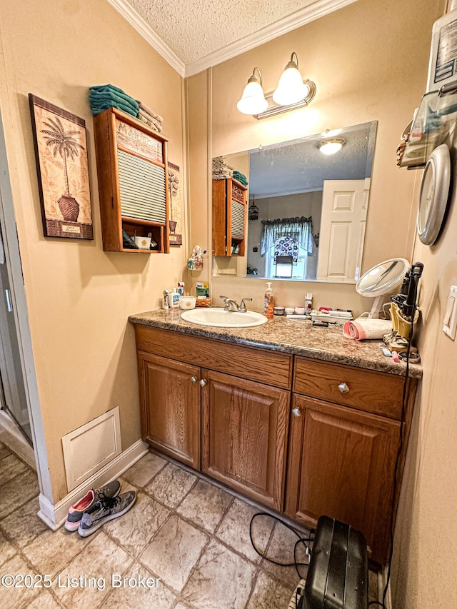 1073 Post-Tousey Rd Unit C, Caneyville, KY 42721 - bathroom with a textured ceiling, crown molding, vanity, and baseboards