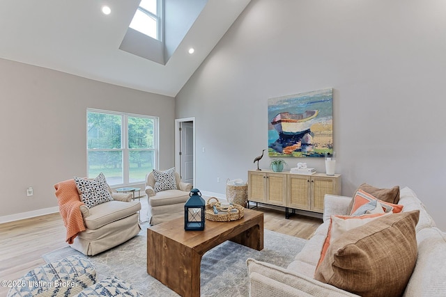 2519 Belknap Beach Rd, Prospect, KY 40059 - living room with high vaulted ceiling, a skylight, light wood finished floors, baseboards, and recessed lighting