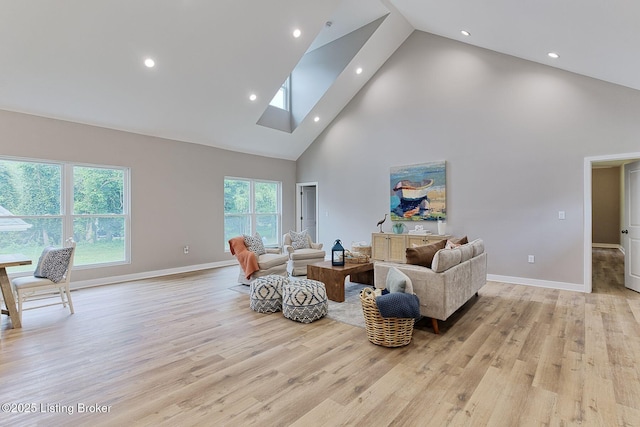 2519 Belknap Beach Rd, Prospect, KY 40059 - living area with high vaulted ceiling, light wood finished floors, baseboards, recessed lighting, and a skylight