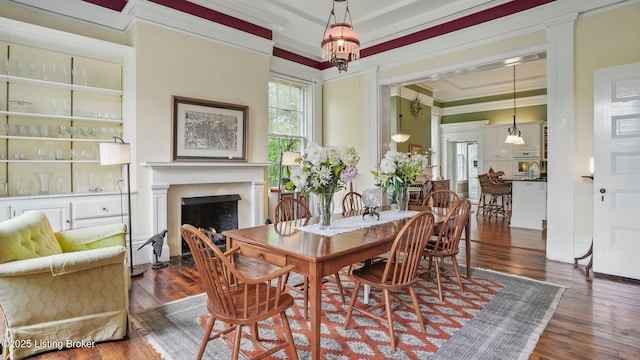 316 E Cross Main St, New Castle, KY 40050 - dining space featuring crown molding, hardwood / wood-style floors, a fireplace with flush hearth, and a chandelier