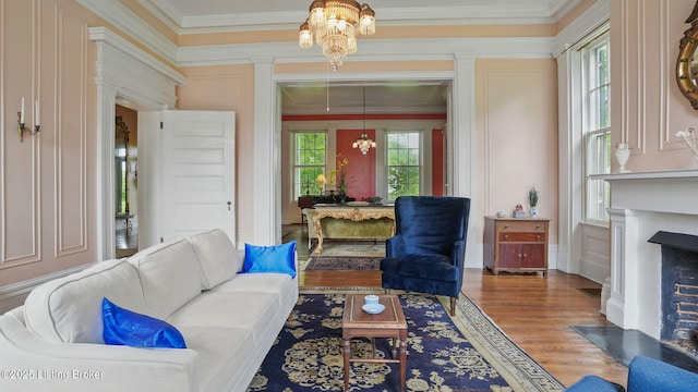 316 E Cross Main St, New Castle, KY 40050 - living area featuring a chandelier, crown molding, a fireplace with flush hearth, and wood finished floors