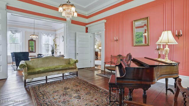 316 E Cross Main St, New Castle, KY 40050 - sitting room featuring a chandelier, ornamental molding, wood-type flooring, and a decorative wall