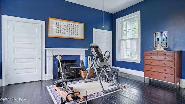 316 E Cross Main St, New Castle, KY 40050 - workout area with wood-type flooring, baseboards, and a fireplace with flush hearth
