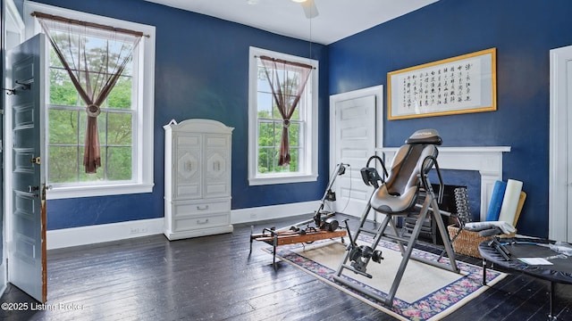 316 E Cross Main St, New Castle, KY 40050 - exercise room with wood-type flooring, a ceiling fan, baseboards, and a fireplace