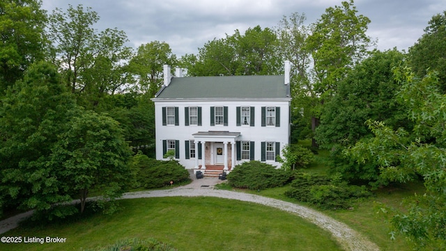 316 E Cross Main St, New Castle, KY 40050 - view of front of home featuring a chimney, a front yard, metal roof, view of wooded area, and curved driveway