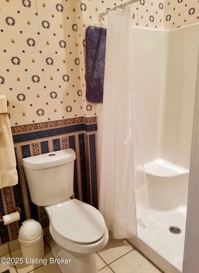 316 E Cross Main St, New Castle, KY 40050 - bathroom with wallpapered walls, a shower stall, toilet, tile patterned floors, and a wainscoted wall