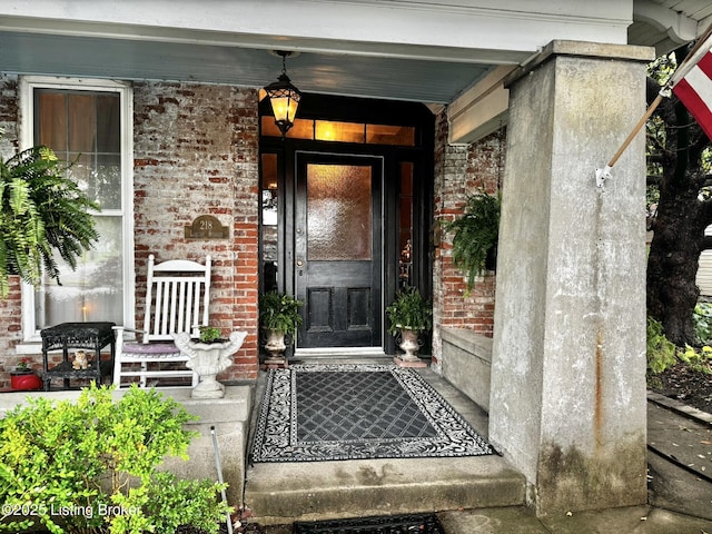 218 Locust St, Jeffersonville, IN 47130 - doorway to property with brick siding and a porch