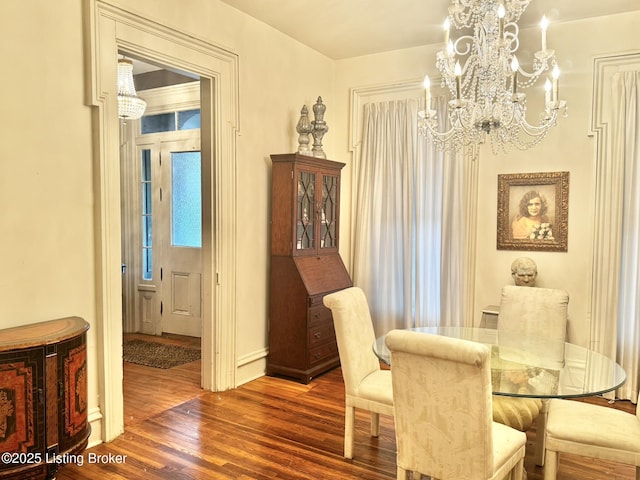 218 Locust St, Jeffersonville, IN 47130 - dining space featuring a chandelier, wood finished floors, and baseboards